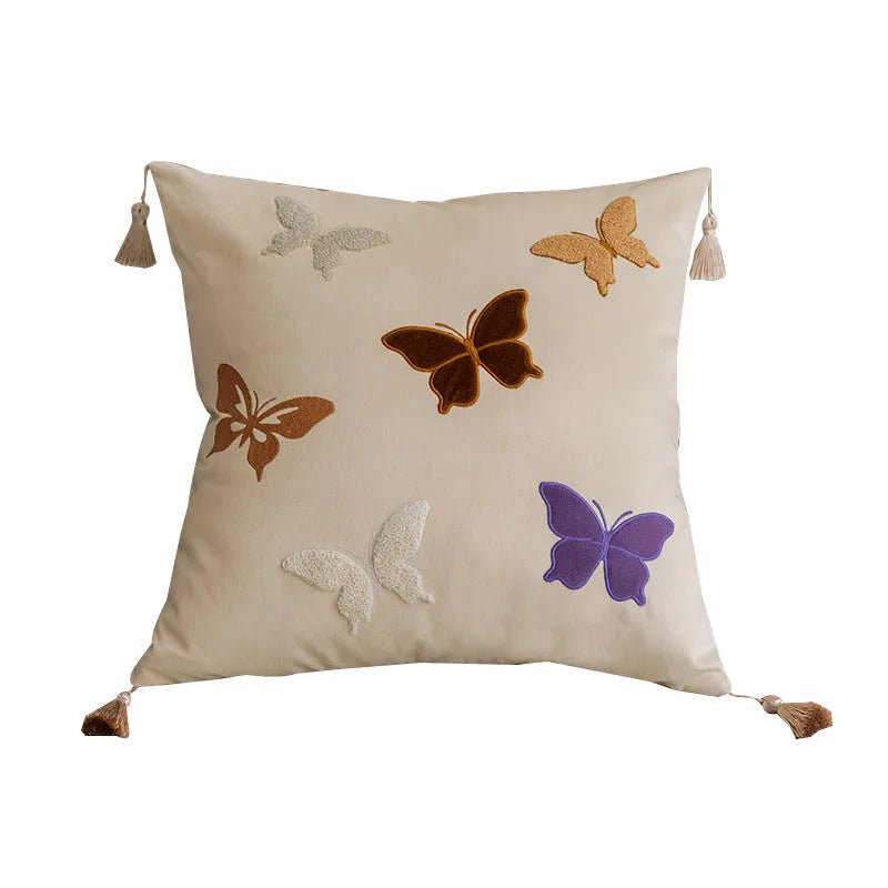 Square decorative cushion with Chinese butterfly embroidery in beige, black, and purple threads.