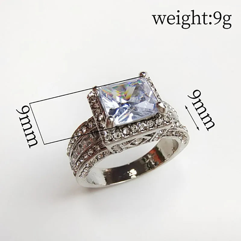 A geometric silver-tone women's ring with round elements, shown in gold and white colour options.