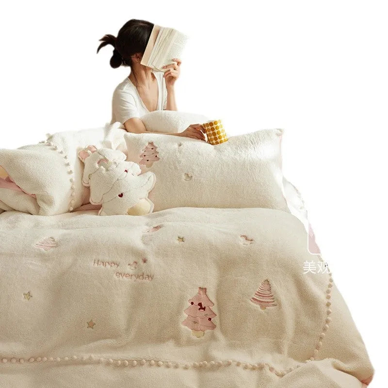 Winter milk fibre princess-style bedding four-piece set with green Christmas tree pattern on a bed.