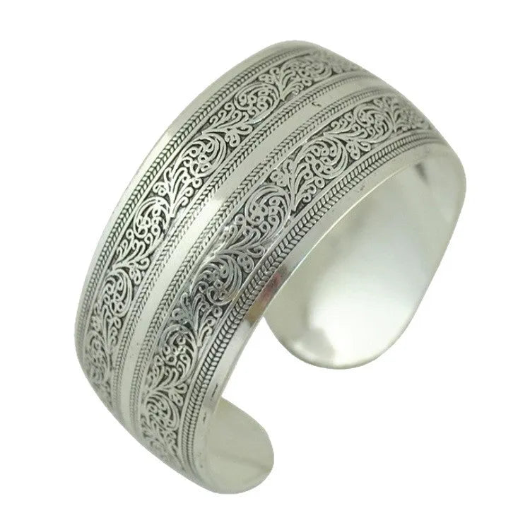 Carved open ethnic bracelet with Miao silver style design in alloy material showing elephant or turtle colour motifs