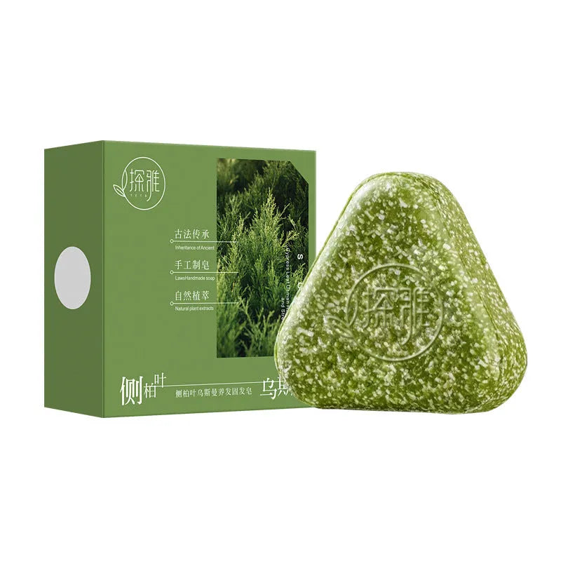 Rectangular bar of Chinese arborvitae twig Usman herbal soap on a wooden surface.