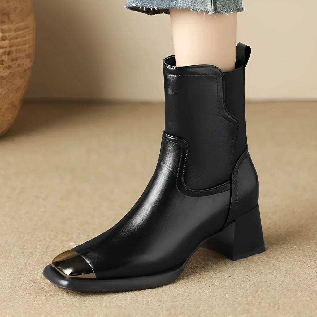 Brown cowhide leather women's Martin boots with a high heel and side zipper detail.
