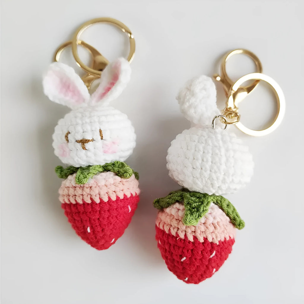 Hand-woven white rabbit strawberry pendant keychain made from four-strand doll wire.