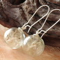 Transparent glass ball earrings with a dandelion seed inside, on a silver French hook.