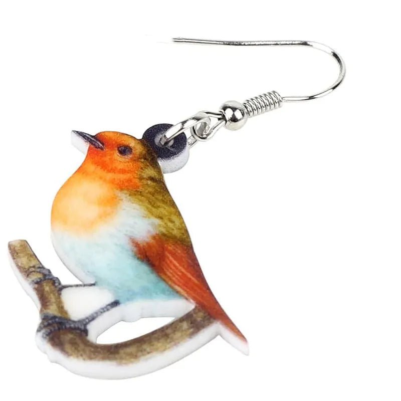 Acrylic clip-on earrings with a blue titmouse bird and geometric snake design.