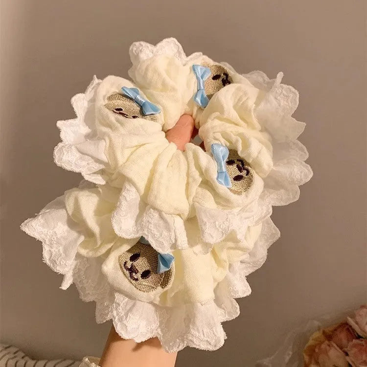 Bear blue large intestine hair ring with a cloth bow and lace detail on a stretchable headband.