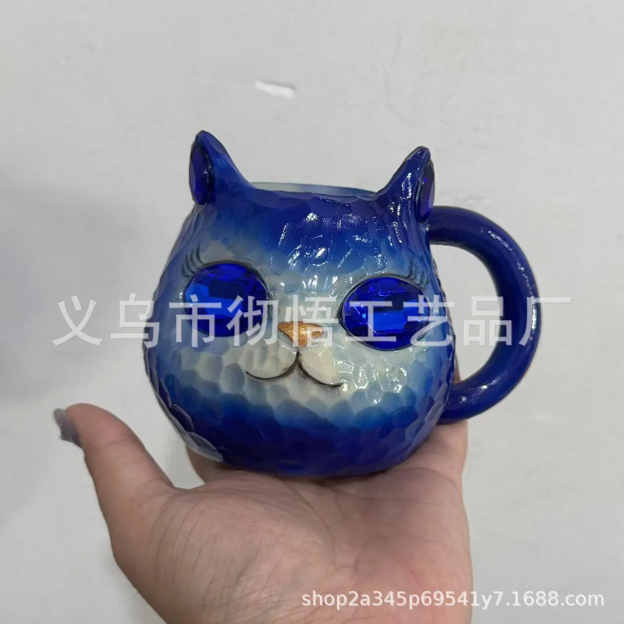 Resin cat cup crystal globe decorative ornament on a desk, shown in purple colour.