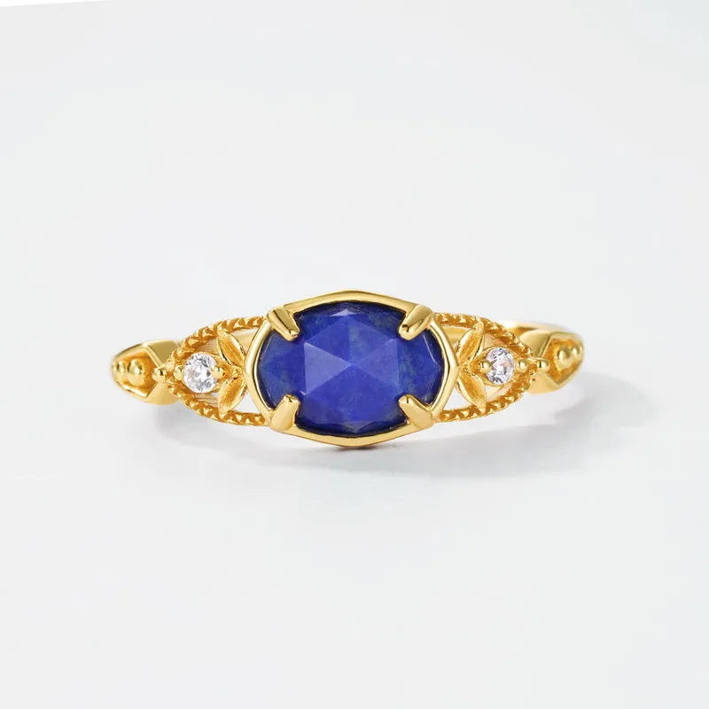 Geometric silver alloy ring with blue lapis lazuli stone centrepiece, elliptical Japanese style design.