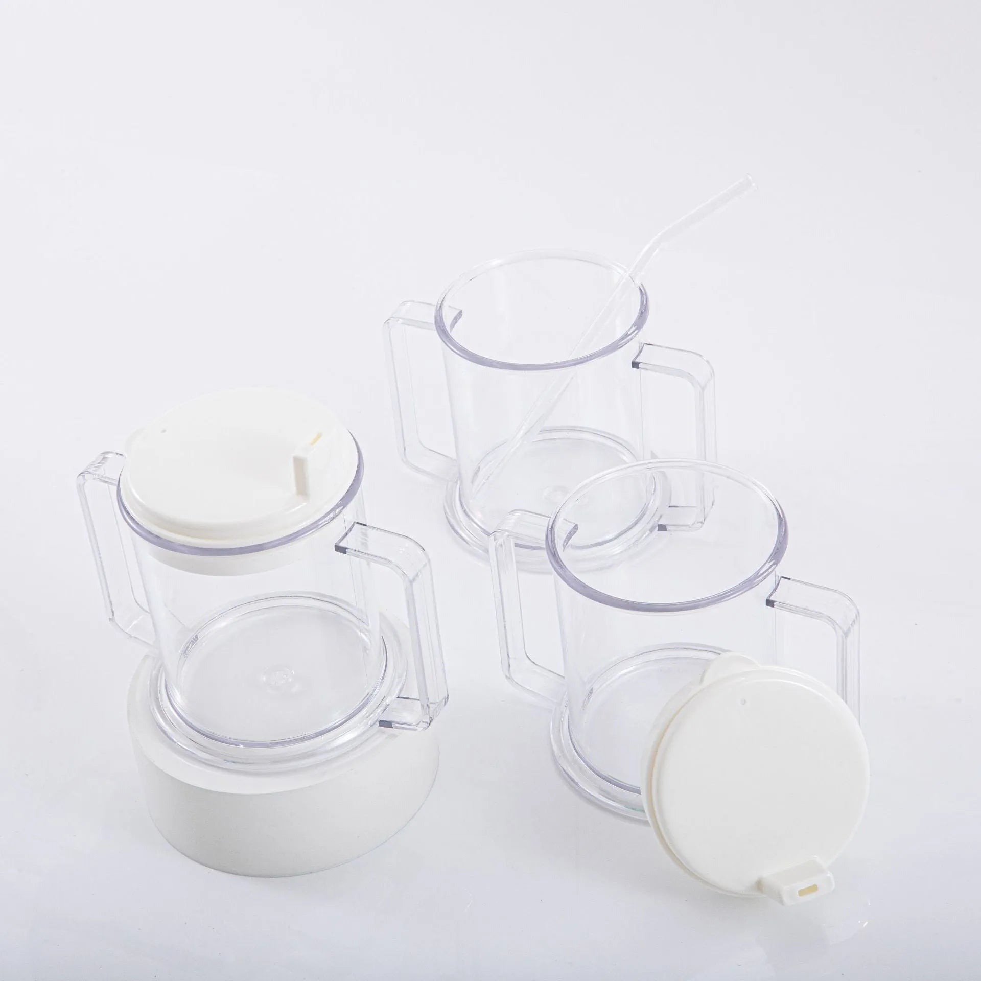 Transparent spill-proof plastic drinking cup with modern design on a plain background.