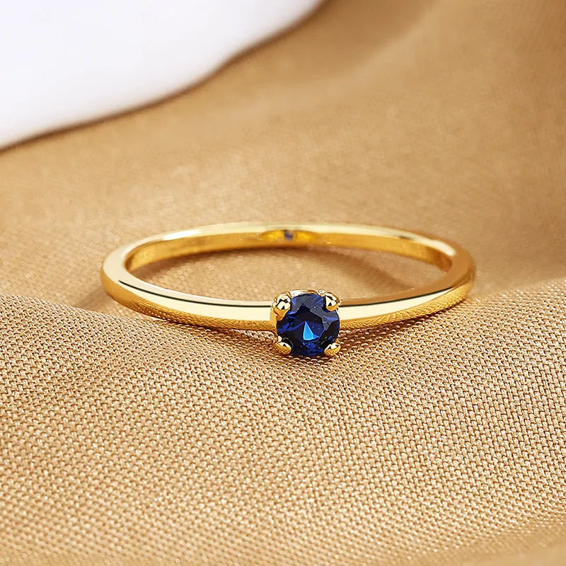 Women's geometric copper ring with single diamond in circle design showing colour options