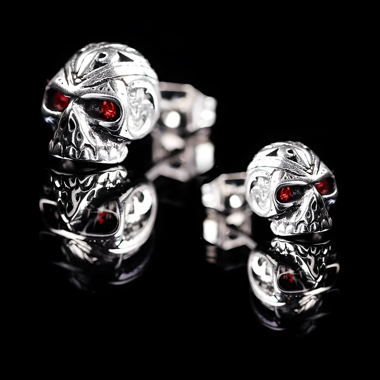 Retro skull stud earrings with ghost head design and red eye detail on alloy background