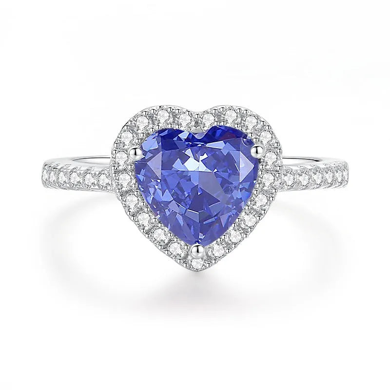 Heart-shaped sterling silver ring with a faceted colour zircon stone on a white background.