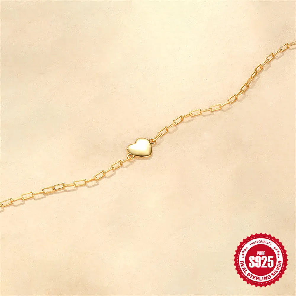 Gold plated S925 sterling silver bracelet with heart charm and geometric clip chain on wrist