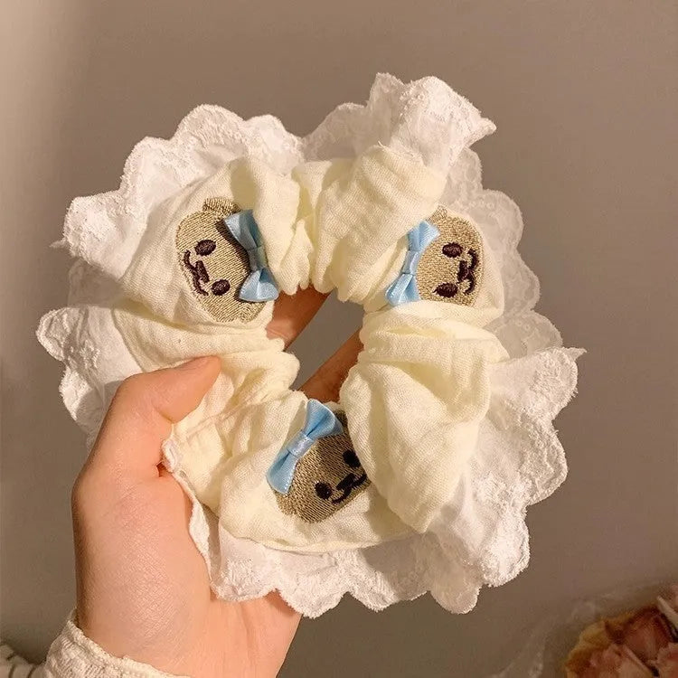 Bear blue large intestine hair ring with a cloth bow and lace detail on a stretchable headband.