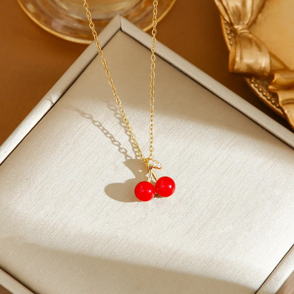 Golden indie necklace with detailed cherry, strawberry, and pepper pendant on a titanium steel O-ring chain.