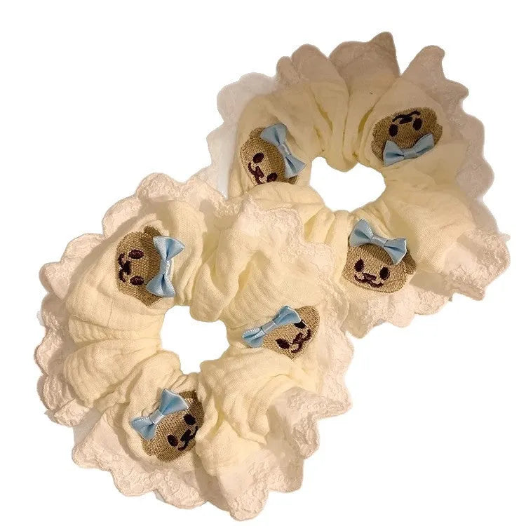 Bear blue large intestine hair ring with a cloth bow and lace detail on a stretchable headband.