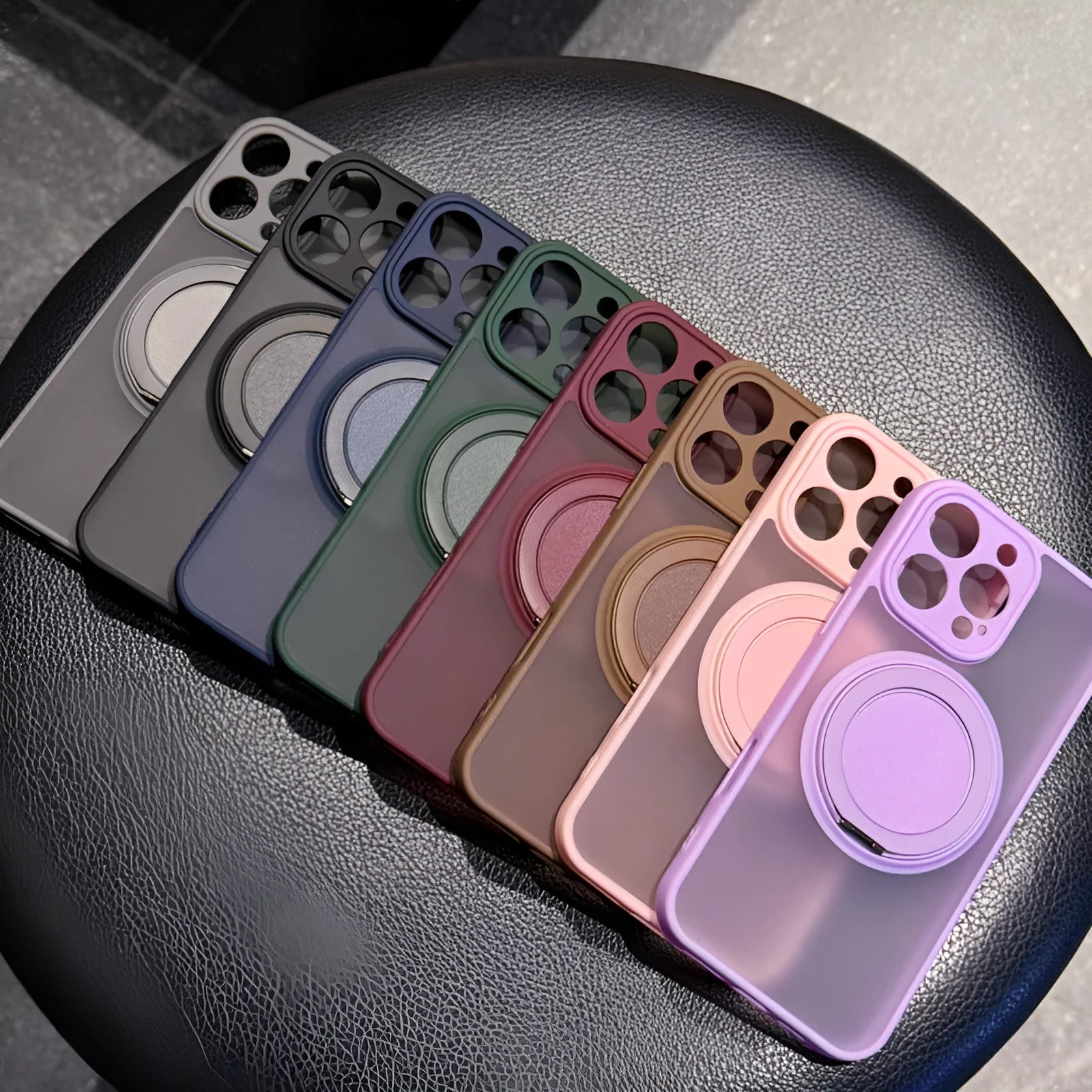 Frosted transparent magnetic phone case with a built-in stand for iPhone, shown in plum colour.