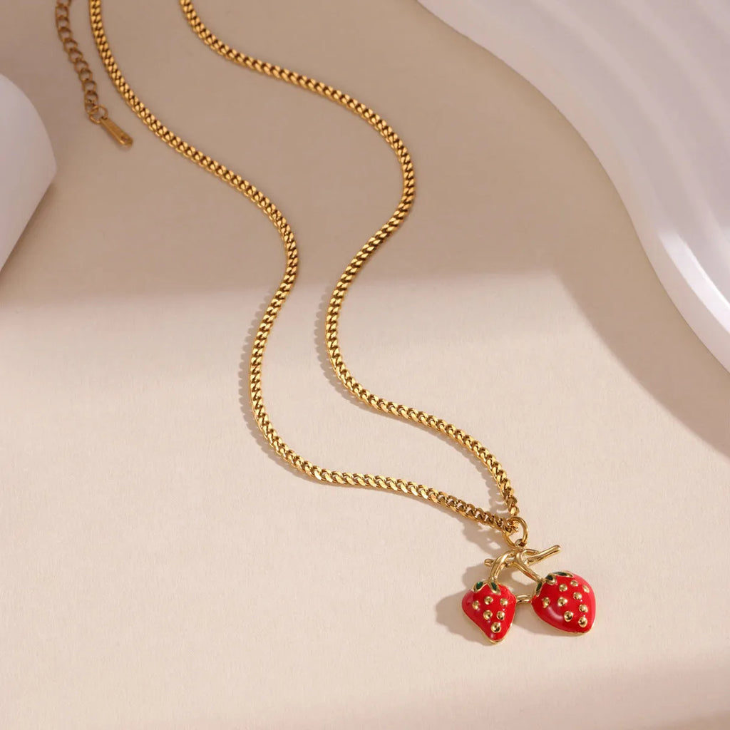 Stainless steel strawberry-shaped pendant necklace on an alloy chain in red or white gradient finish.
