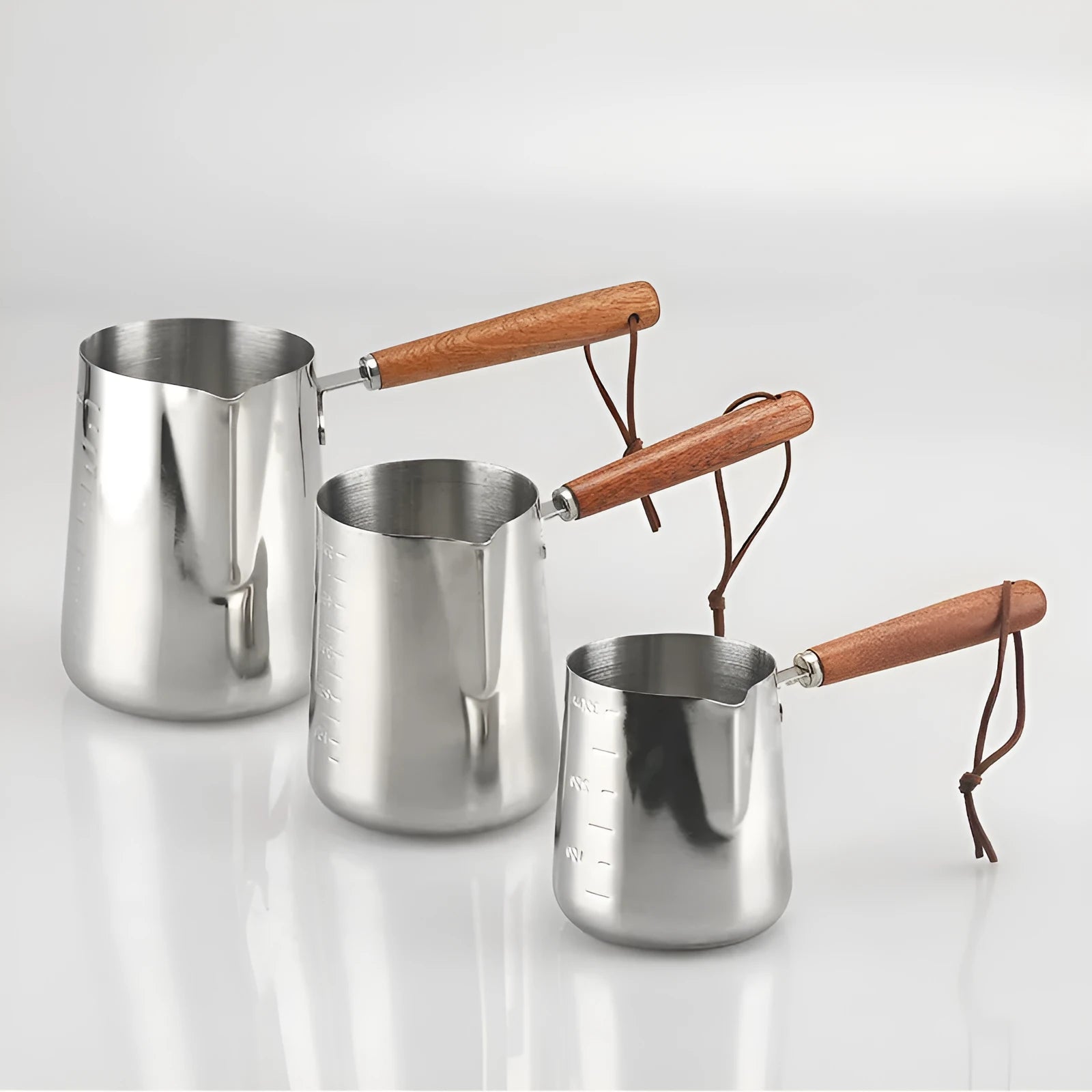Stainless steel latte art milk cup with wooden handle and interior measuring scale