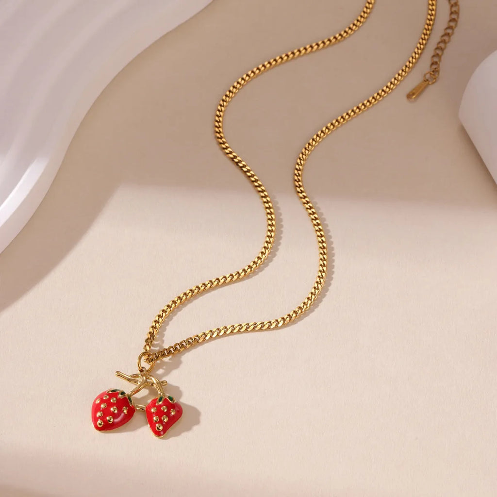 Stainless steel strawberry-shaped pendant necklace on an alloy chain in red or white gradient finish.