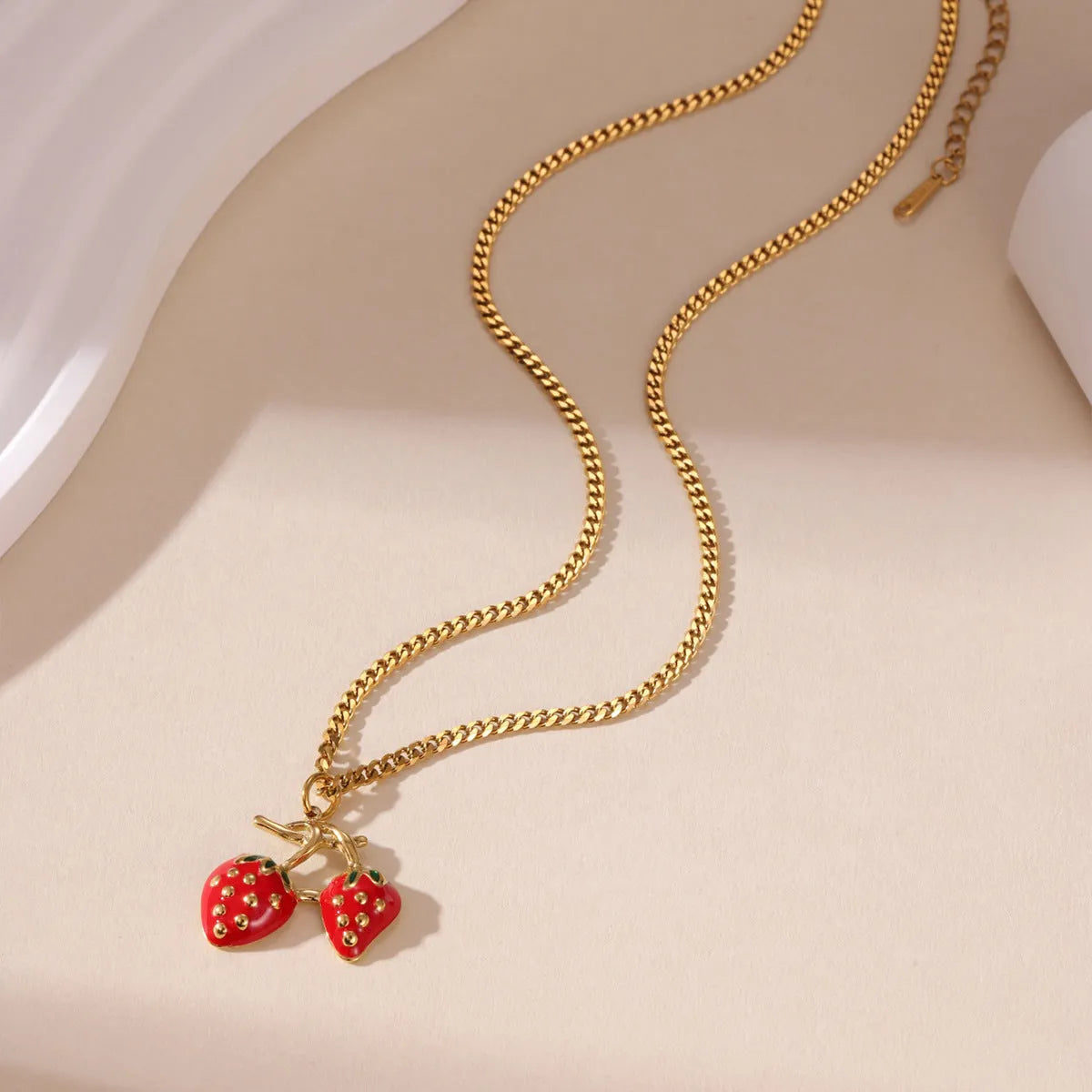 Stainless steel strawberry-shaped pendant necklace on an alloy chain in red or white gradient finish.