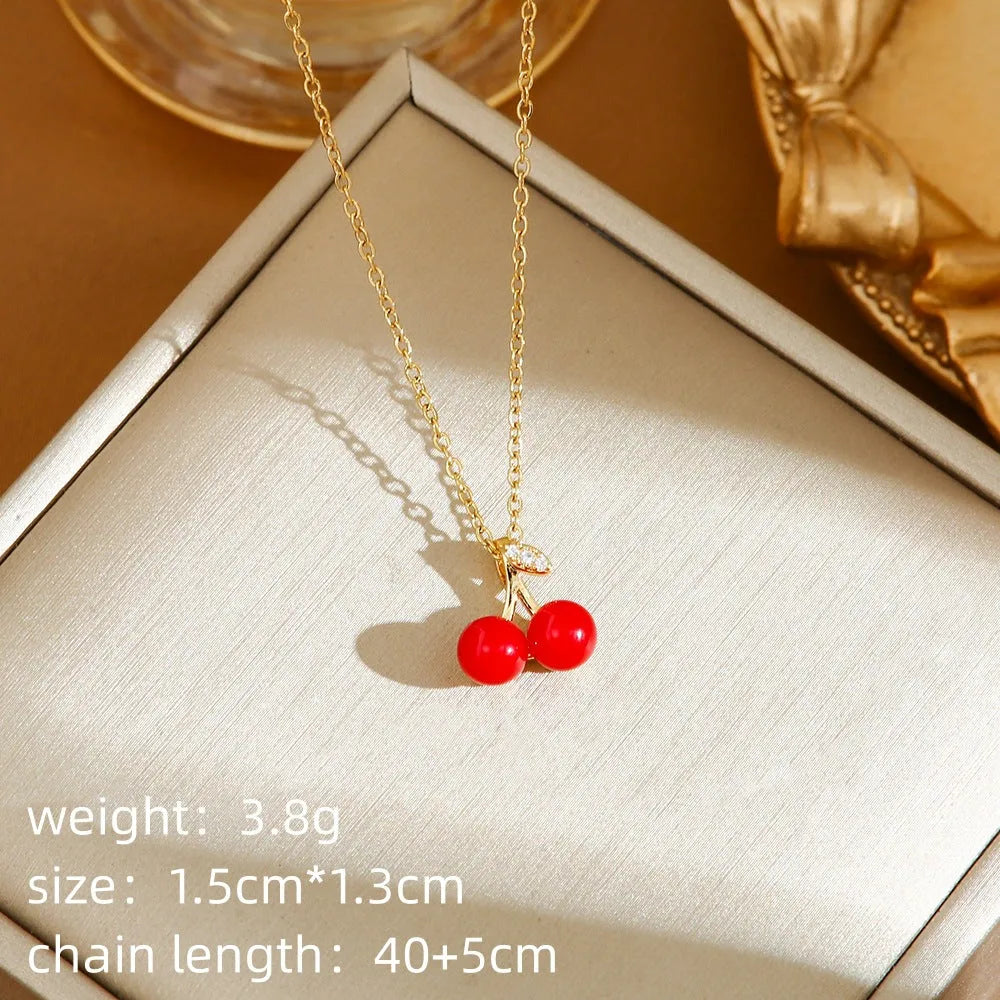 Golden indie necklace with detailed cherry, strawberry, and pepper pendant on a titanium steel O-ring chain.