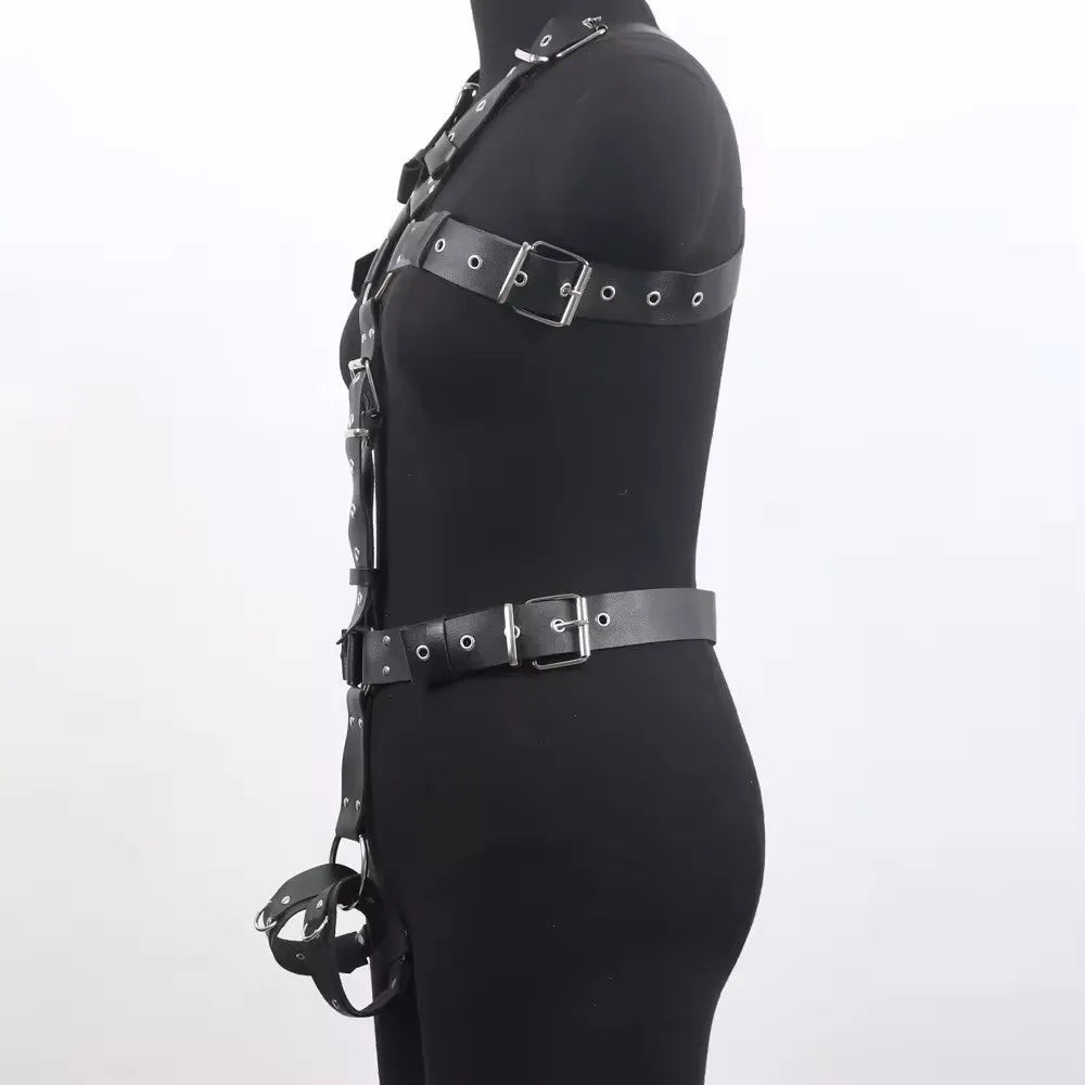 Black patent leather finish shapewear bodysuit with thin straps and a front pin buckle closure.