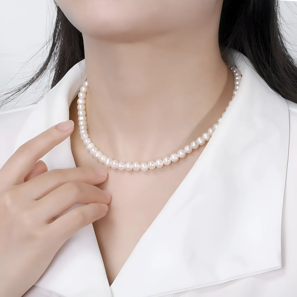Close-up of a women's adjustable necklace with freshwater pearls on a sterling silver chain.
