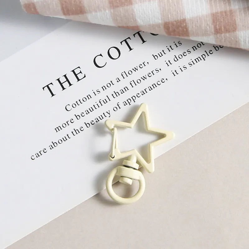 Metal five-pointed star snap button keychain with colour paint finish in alloy, small size, thirteen colour options including beige and sapphire blue
