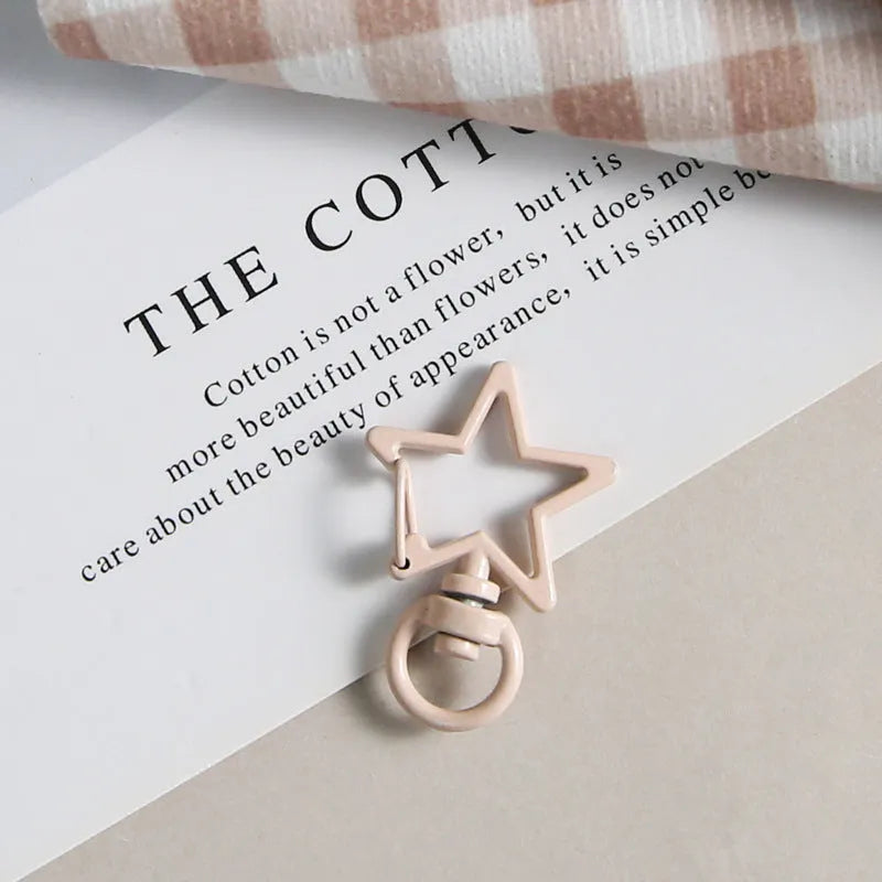 Metal five-pointed star snap button keychain with colour paint finish in alloy, small size, thirteen colour options including beige and sapphire blue