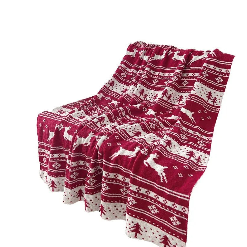 Christmas acrylic blanket with snowflake pattern in 110x130cm size on sofa