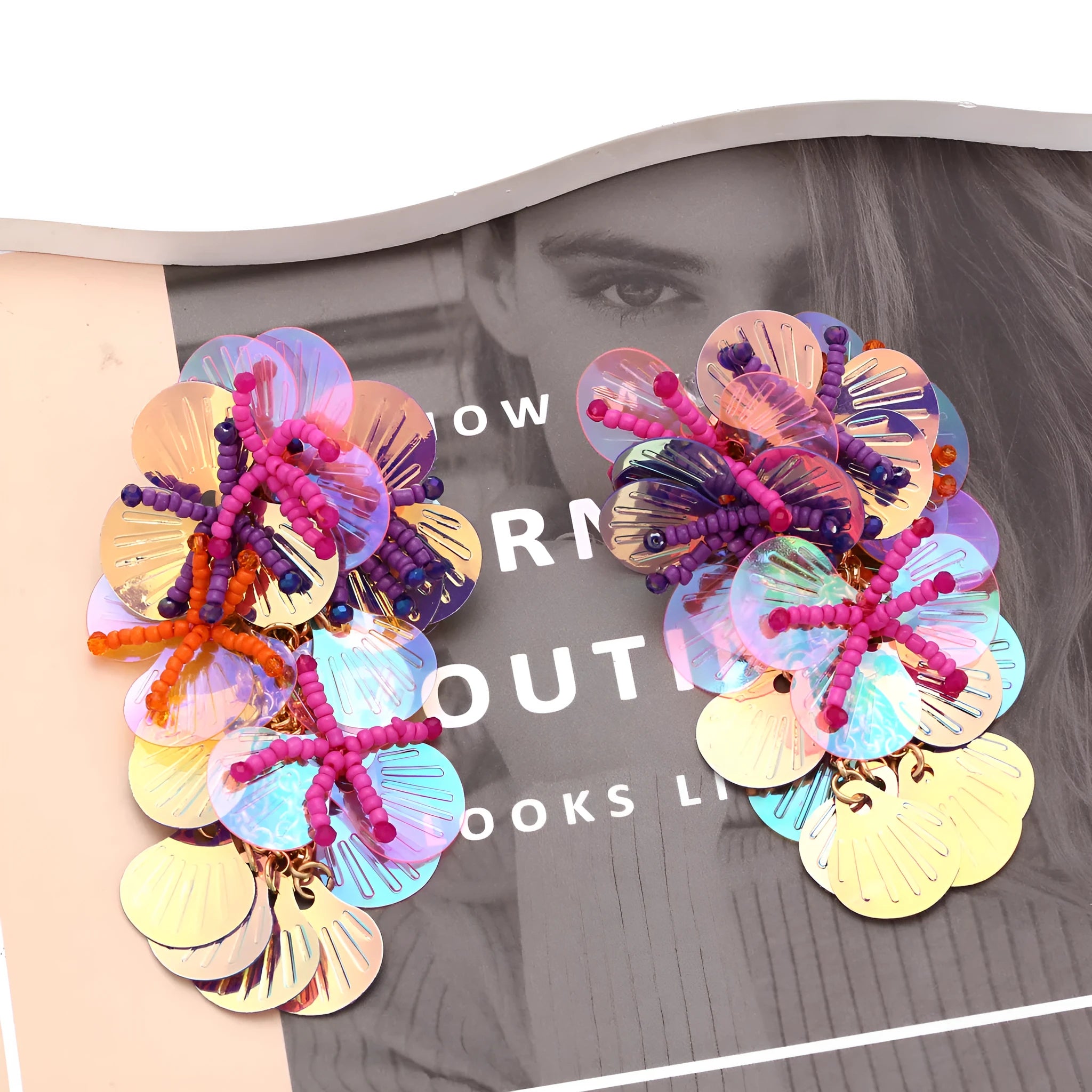 A pair of handmade colourful string bead flower and leaf earrings in an exaggerated design.