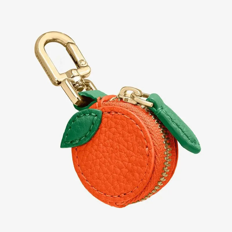 Mini solid colour PU leather coin pouch keychain in cherry red on a keyring.