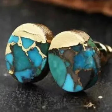 Close-up of handcrafted bohemian stud earrings with an irregular natural stone in colour ER1031 on a simple metal setting.