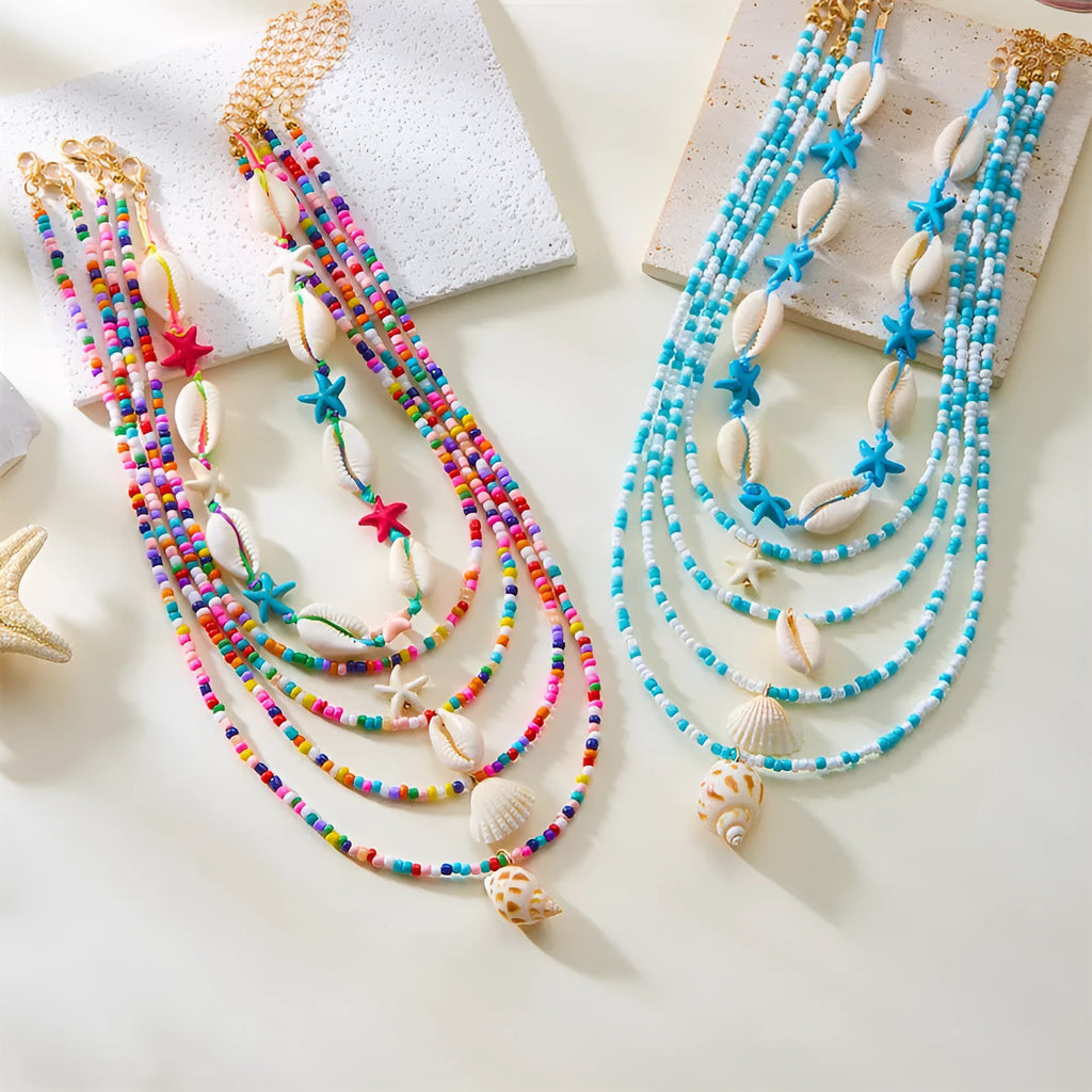 Five women's fashion necklaces with starfish and shell bead designs in blue and multicolour options
