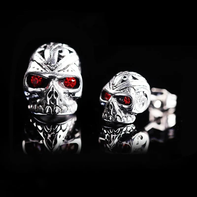 Retro skull stud earrings with ghost head design and red eye detail on alloy background
