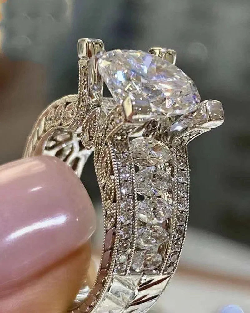 A geometric silver-tone women's ring with round elements, shown in gold and white colour options.