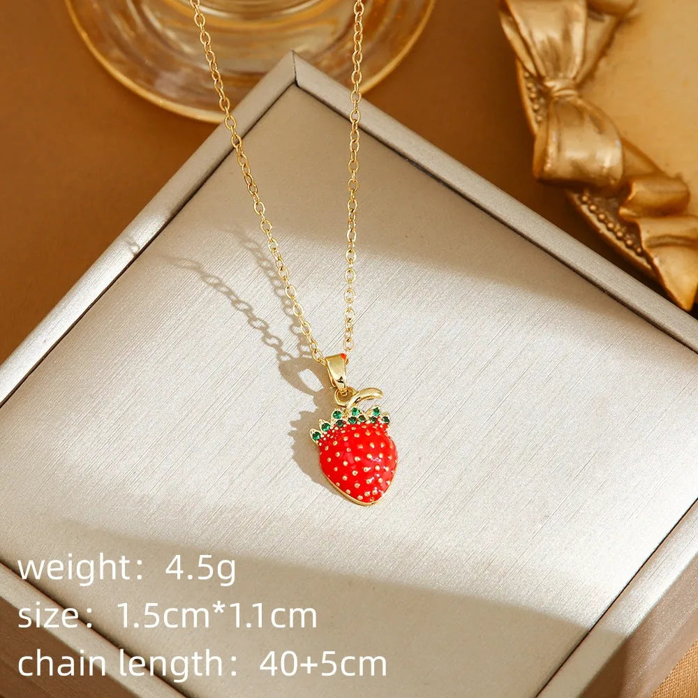 Golden indie necklace with detailed cherry, strawberry, and pepper pendant on a titanium steel O-ring chain.