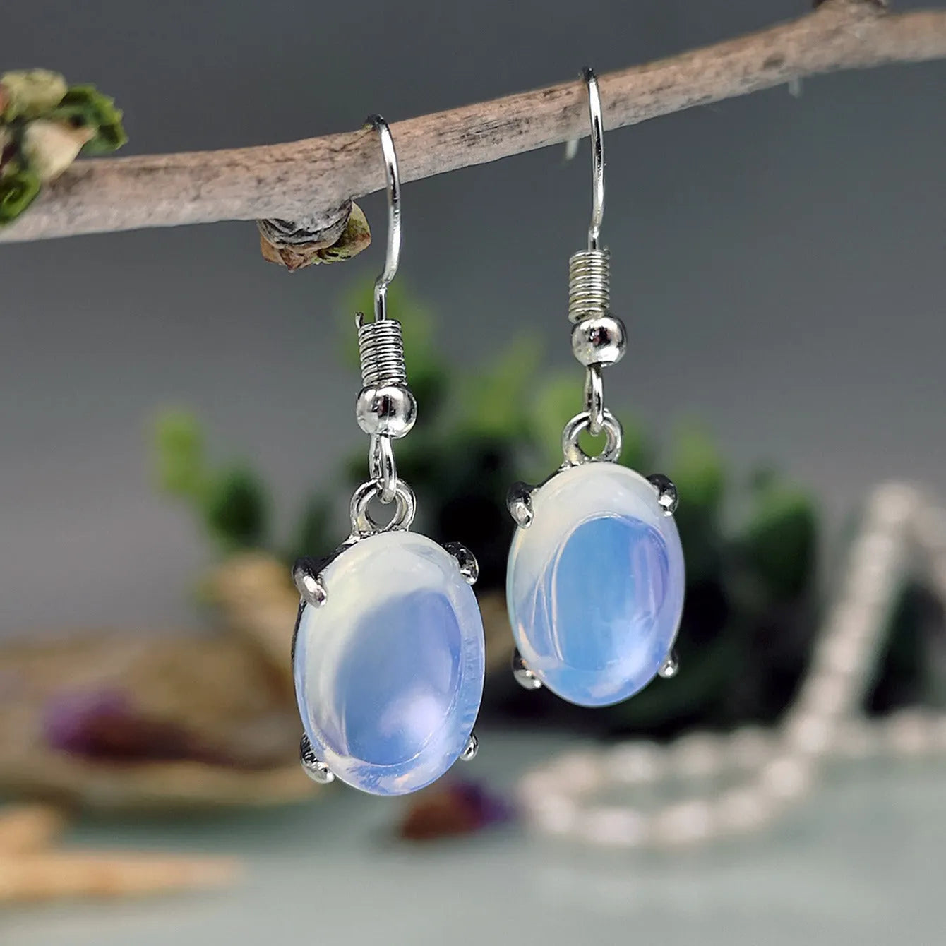 Moonlight white opal drop earrings with elliptical cross design on alloy electroplated setting