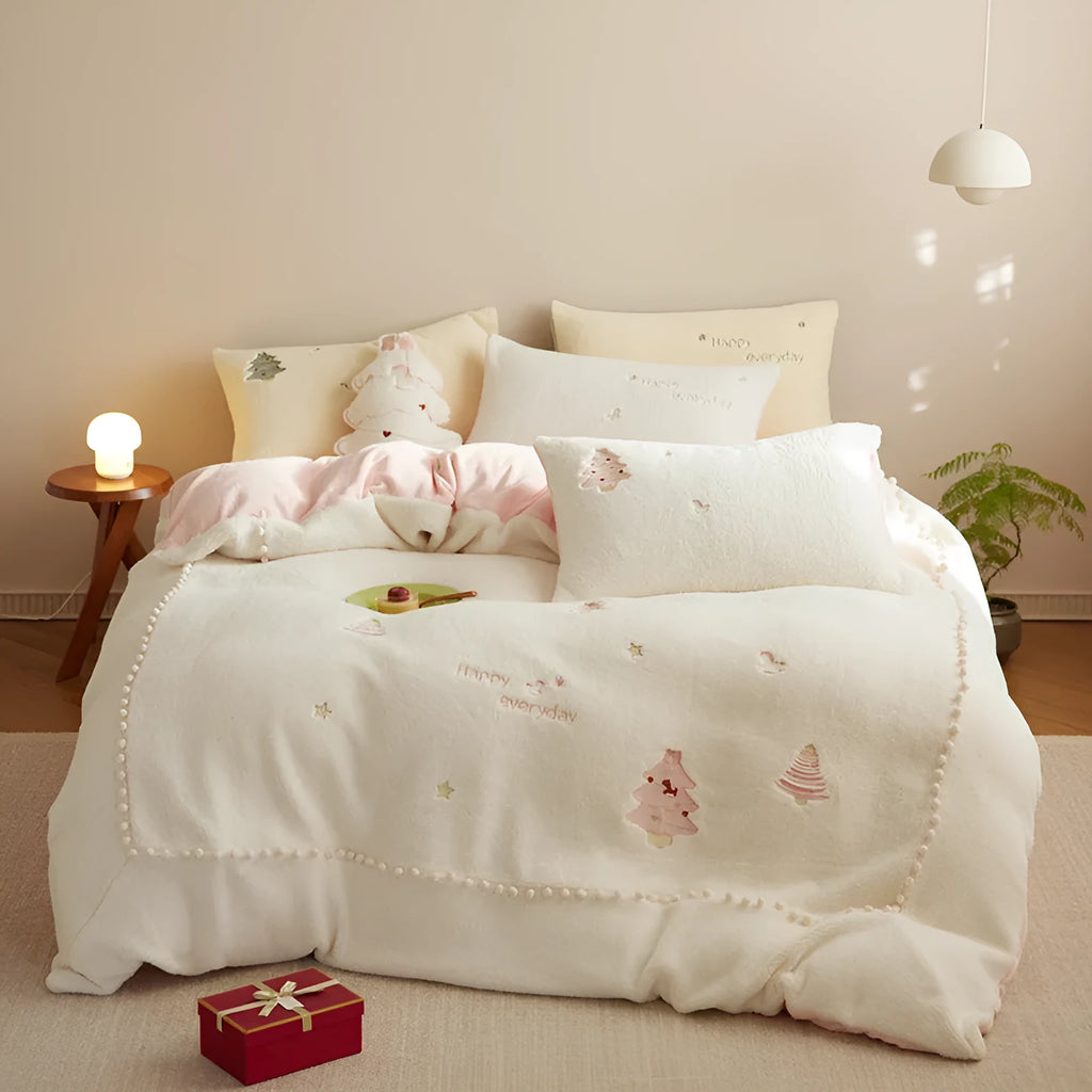 Winter milk fibre princess-style bedding four-piece set with green Christmas tree pattern on a bed.