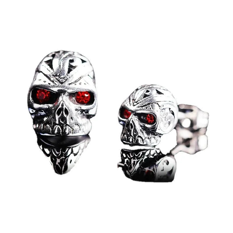 Retro skull stud earrings with ghost head design and red eye detail on alloy background