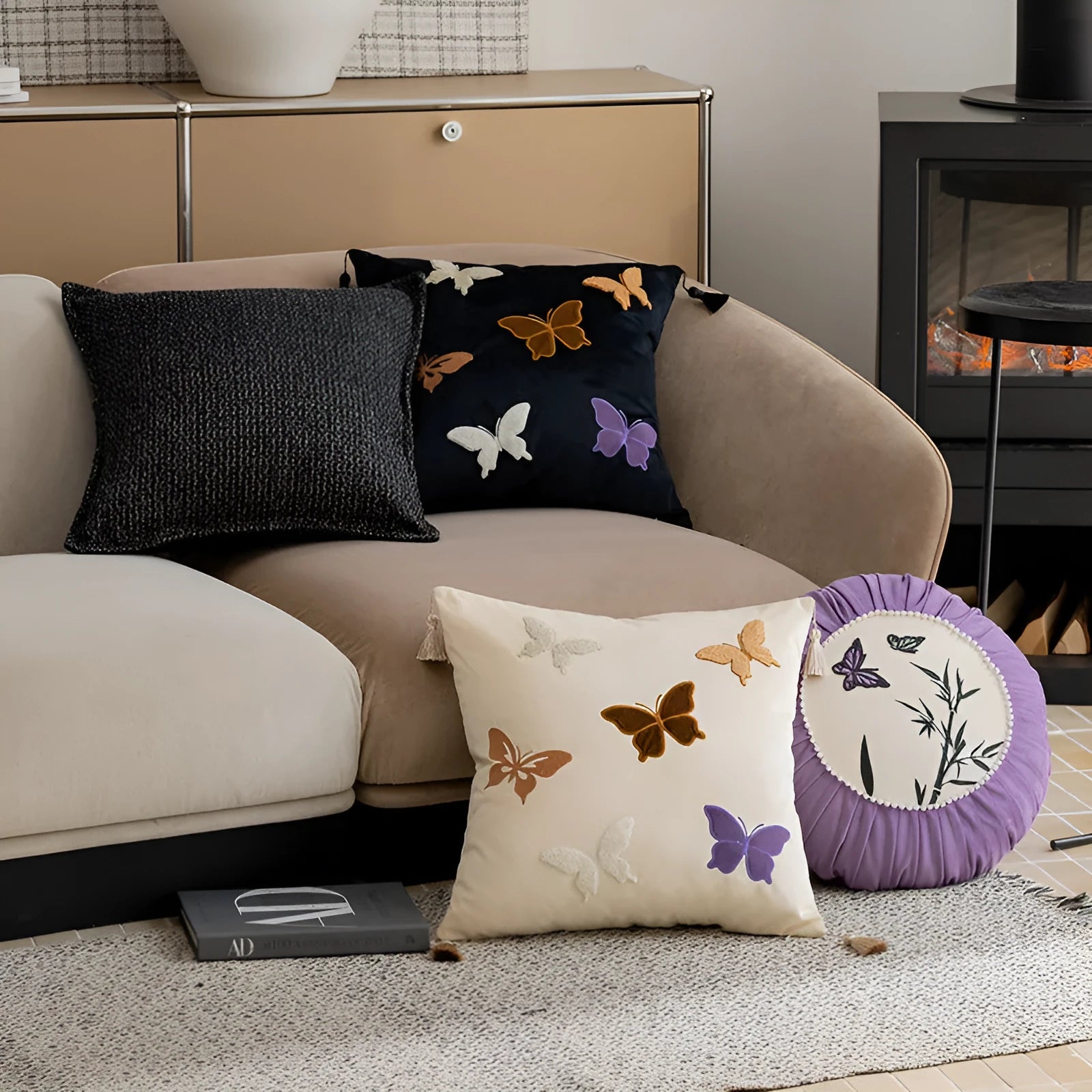 Square decorative cushion with Chinese butterfly embroidery in beige, black, and purple threads.