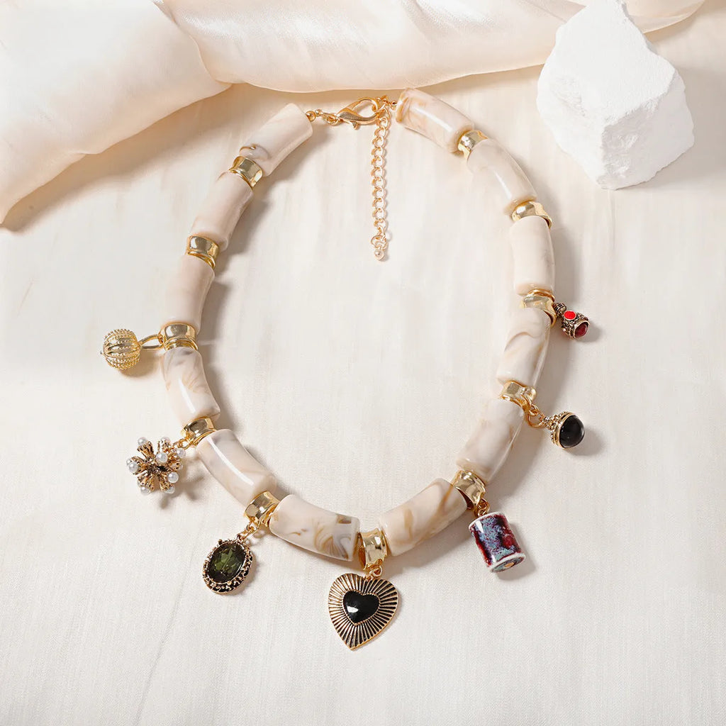 Heart-shaped resin and plastic pendant necklace with an electroplated finish for women.