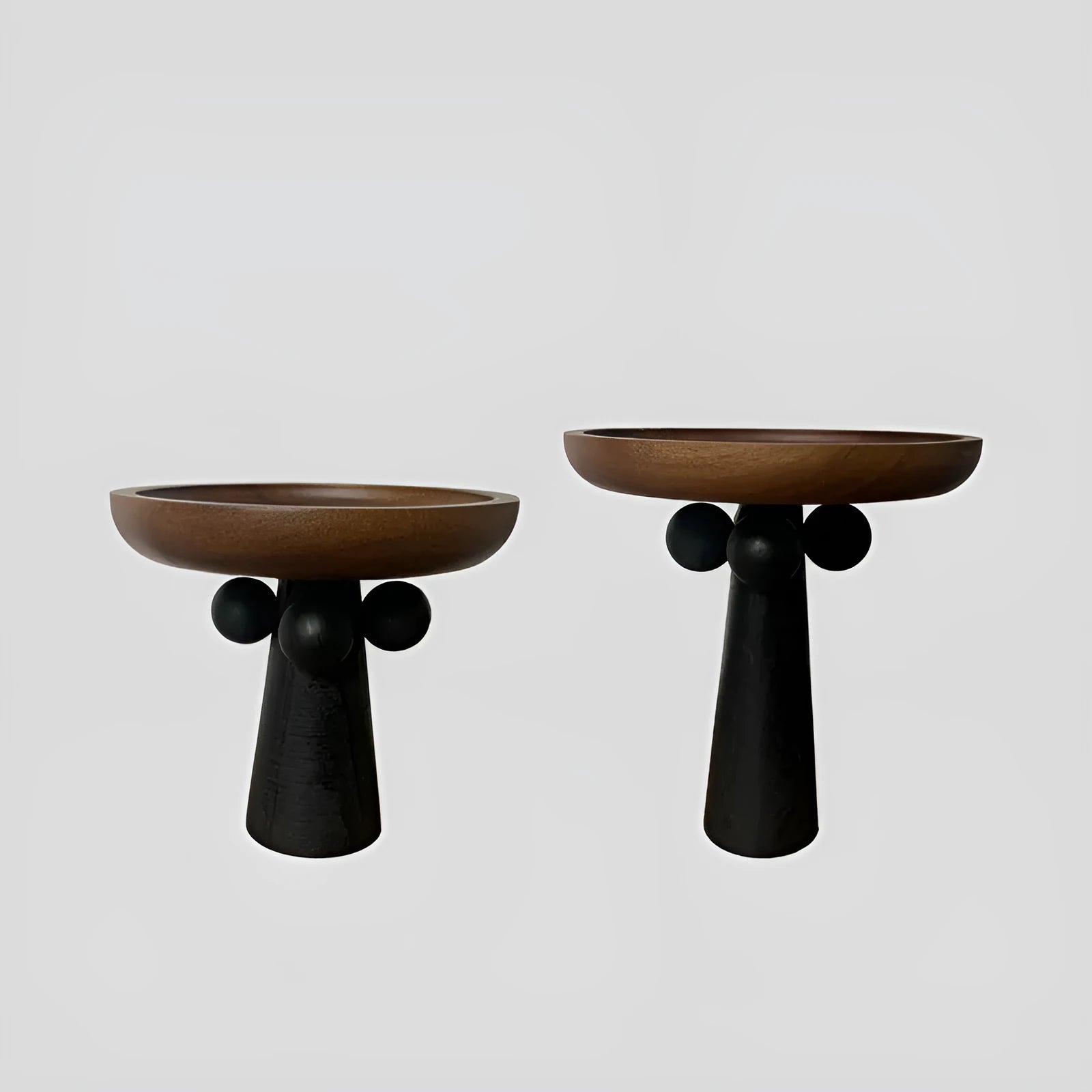 High-legged round wooden tray in a modern Nordic style for candle and decor display.