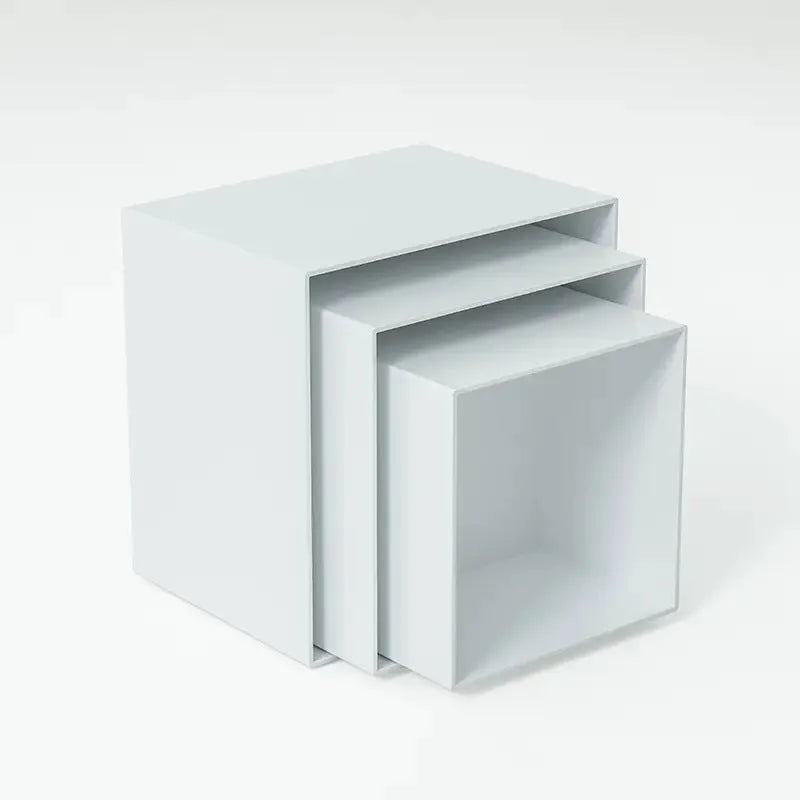 White plastic cube dessert display stand set of six pieces arranged on a table.