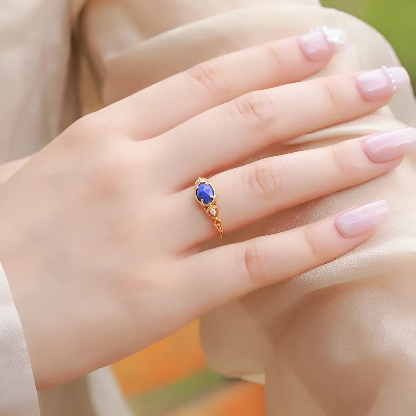 Geometric silver alloy ring with blue lapis lazuli stone centrepiece, elliptical Japanese style design.