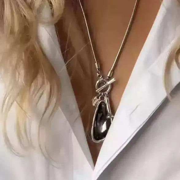 Long women's necklace with geometric alloy pendant on snake bones chain in plaid pattern