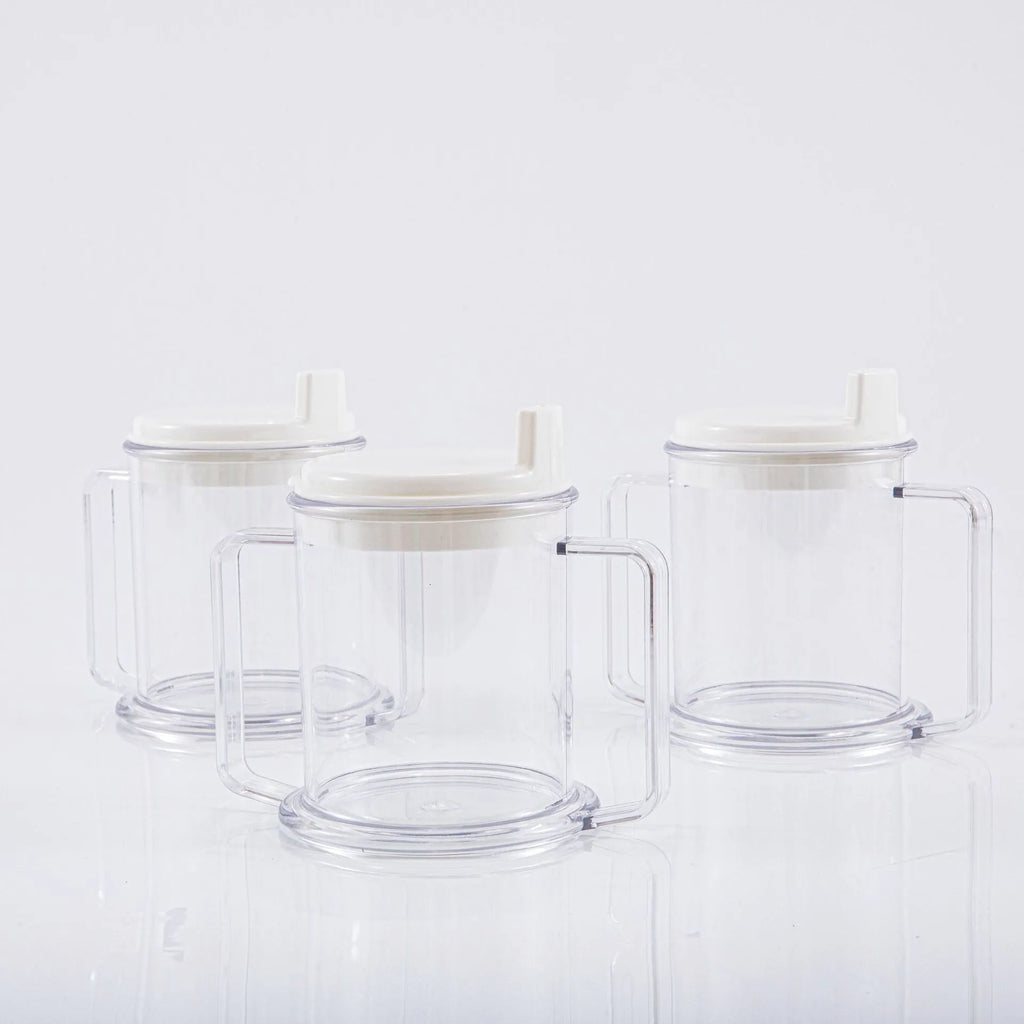 Transparent spill-proof plastic drinking cup with modern design on a plain background.