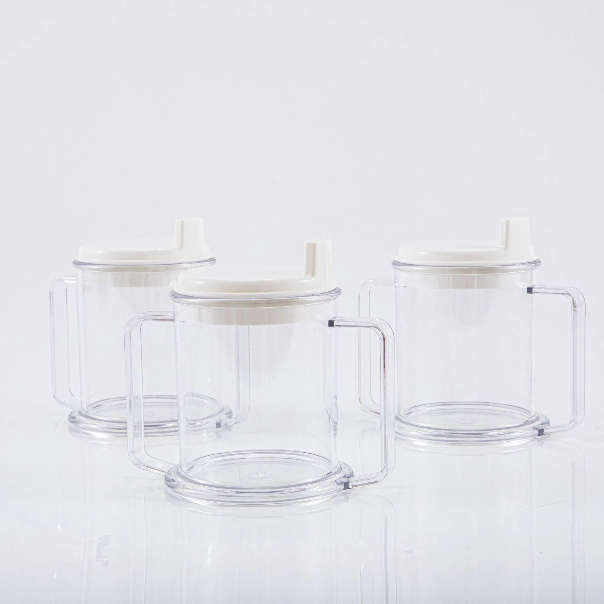 Transparent spill-proof plastic drinking cup with modern design on a plain background.