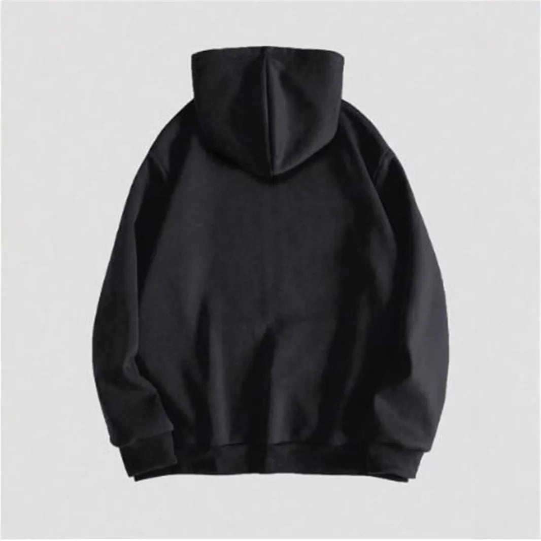 Man wearing a black hooded sweatshirt with a large white skull print on the front.